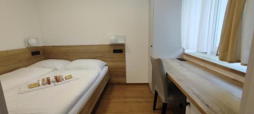 a bedroom with a white bed and a window at HANESI apartments Luhačovice in Luhačovice