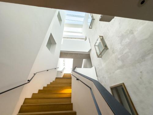 a staircase in a house with white walls and wooden floors at Résidence de l'Arsenal Royal - Meublés de Tourisme in Rochefort