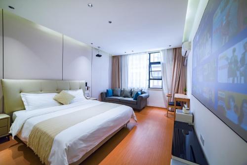 a bedroom with a large bed and a flat screen tv at Zhangjiajie Han Exotic Inn in Zhangjiajie