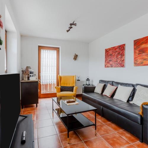 a living room with a couch and a table at Lioda Roccia in Masariè