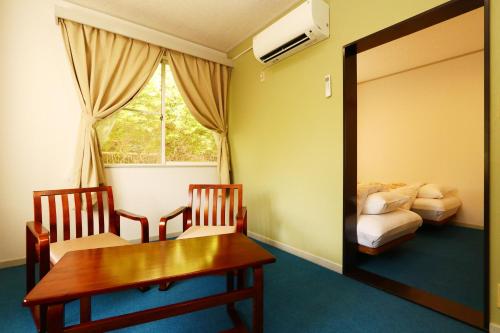 Tempat tidur dalam kamar di Pension Todoroki