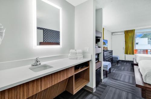 a bathroom with a sink and a bed at Holiday Shores Myrtle Beach in Myrtle Beach