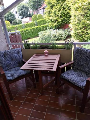 a wooden table and two chairs on a patio at Harzgeist in Goslar