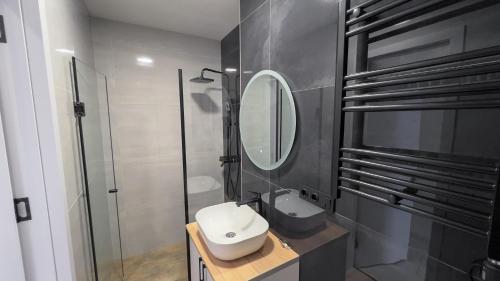 a bathroom with a toilet and a sink and a mirror at Tbilisi Vi64 in Tbilisi City