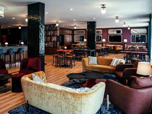 a lobby with couches and tables and a bar at ibis Styles Wałbrzych in Wałbrzych