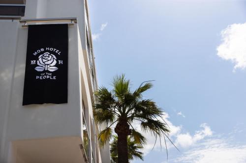 banner na boku budynku z palmą w obiekcie MOB HOTEL Cannes w Cannes