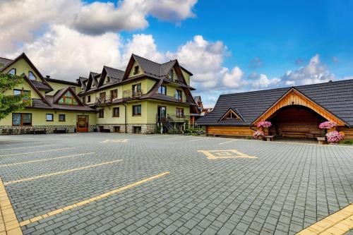 a parking lot in front of a large building at U Haliny in Biały Dunajec