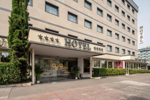 a hotel building with a sign that reads hotel at Hotel American Palace Eur in Rome