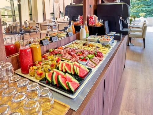 a buffet line with a lot of food and drinks at Best Western Plus Metz Technopole in Metz