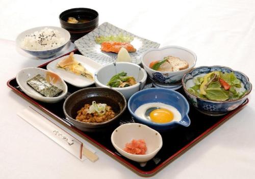 a tray with various dishes of food on a table at APA Hotel Kitakami Ekinishi in Kitakami