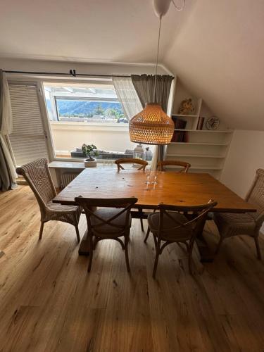 a dining room with a wooden table and chairs at Nannerls Penthouse in Sankt Gilgen