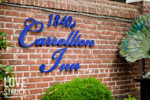 ボルチモアにある1840s Carrollton Innの青い看板が貼られたレンガ壁