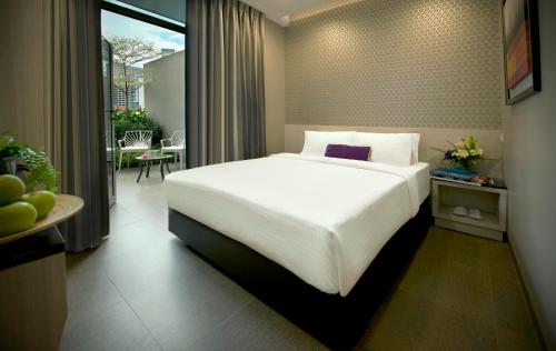 Tempat tidur dalam kamar di V Hotel Bencoolen