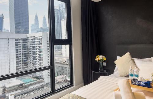 um quarto com uma cama e uma grande janela em Axon Residence KLCC - KL HOME em Kuala Lumpur