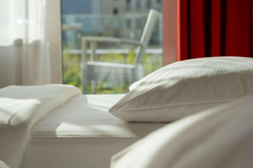 Cama ou camas em um quarto em Park Inn by Radisson Linz