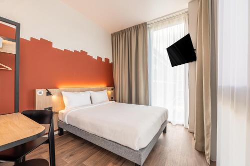 Krevet ili kreveti u jedinici u okviru objekta B&B HOTEL Geneva Airport