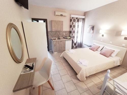 a small room with a bed and a mirror at Studios Thea Fresh Rooms Thassos in Limenas