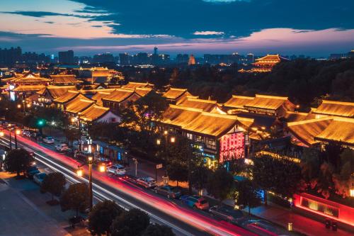 a city lit up at night with buildings and street lights at Gran Melia Xi'an in Xi'an