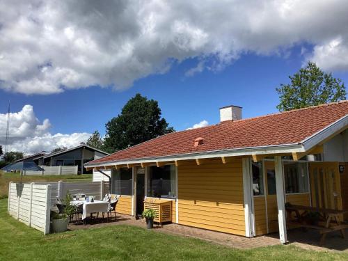 a small house with a patio and a table at Holiday home Aabenraa LXXIX in Aabenraa