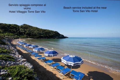 grupa niebieskich parasoli i leżaków na plaży w obiekcie Dimora del Leone Gaeta w mieście Gaeta