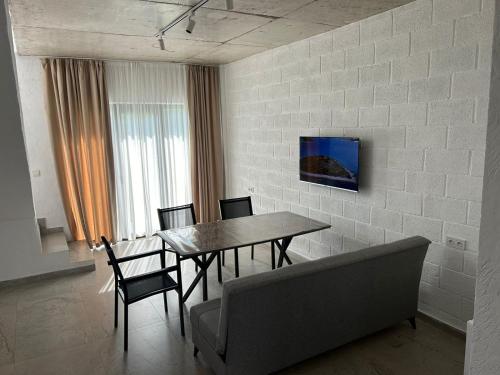 A television and/or entertainment centre at Cottages - Townhouses