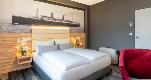 a bedroom with a bed and a picture of a ship at PLAZA Premium Columbus Bremen in Bremen