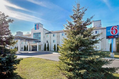 a christmas tree in front of a building at Motel 6-Peterborough, ON in Peterborough