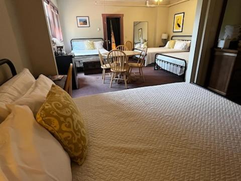 a bedroom with a large bed and a dining room at Gifford House in Provincetown