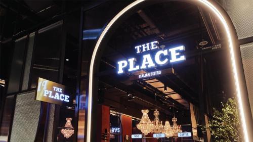 a sign that reads the place in a store window at L7 HONGDAE by LOTTE in Seoul