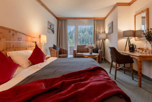 A bed or beds in a room at AROSA ALPINE CLUB - Adults only