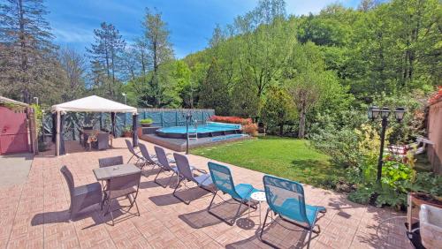 a patio with chairs and a table and a pool at Locanda Le Panche in Pistoia