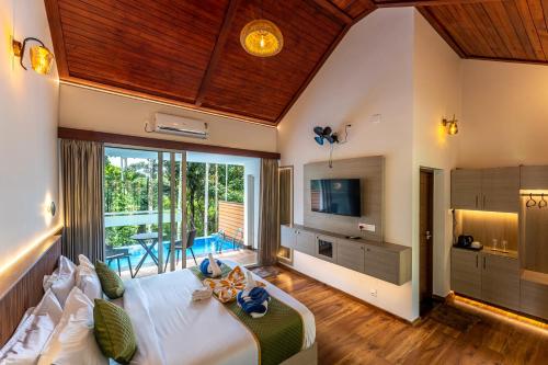 A television and/or entertainment centre at Theyila Wayanad Premium Pool Resort