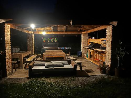 a outdoor patio at night with a bed and a table at Apartments Cederika in Věžovatá Pláně