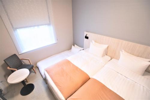 Voodi või voodid majutusasutuse Hiyori Hotel Osaka Namba Station toas