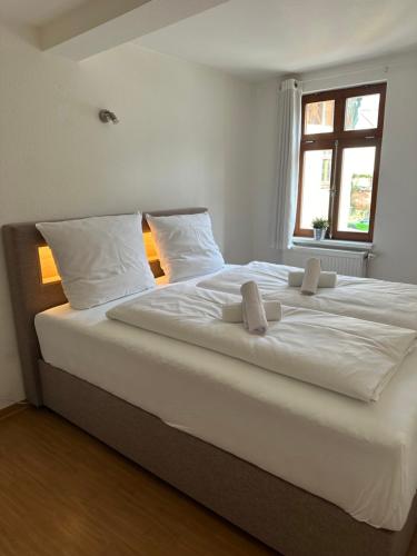 a large white bed in a room with a window at Peter Apartments - Zentrale Innenstadtlage in Fulda