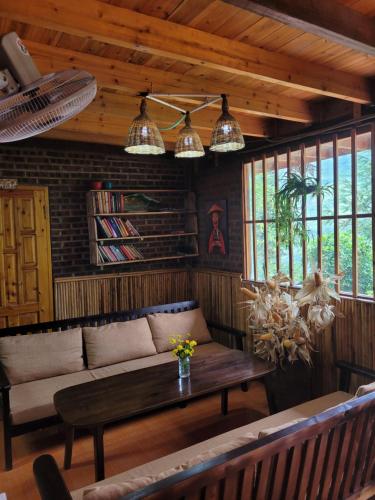 a living room with a couch and a table at Sapa's soul hillside in Sa Pa