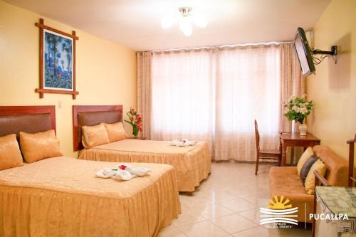 A bed or beds in a room at Hotel Sol del Oriente Pucallpa