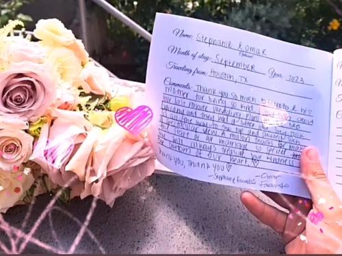 une personne détenant une carte de condoléances à côté d'un bouquet de fleurs dans l'établissement Casa Tutti Frutti, à Positano