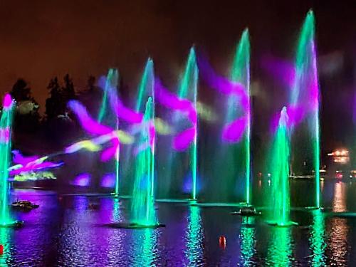 a group of water fountains with purple and green at L'AvantGardiste, Spacious 6 bedroom panoramic view in Crans-Montana