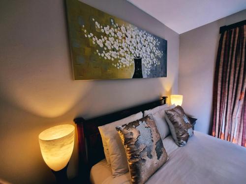 A bed or beds in a room at Cycad Place Midrand Guesthouse and B&B