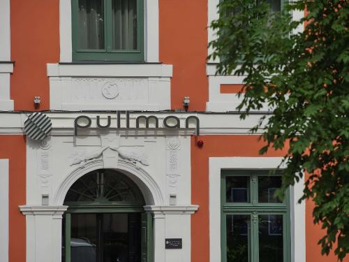 an entrance to a building with the word opinion on it at Pullman Riga Old Town in Rīga