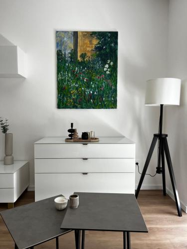 a living room with a dresser and a painting at Fewo Altes Rathaus in Bamberg