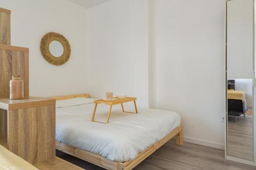 a bedroom with a bed with a table on it at Le Péruvien - Saint-Cyr-L'Ecole - Free Parking in Saint-Cyr-lʼÉcole