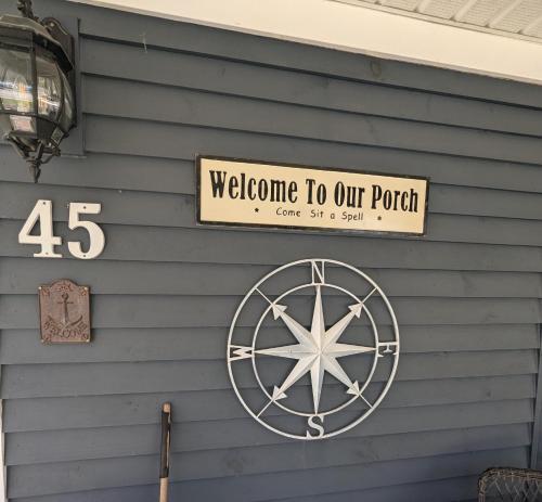 a sign that says welcome to our porch on a house at Rose & Thistle B&B Lunenburg in Lunenburg