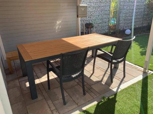 - une table en bois et 2 chaises sur la terrasse dans l'établissement Carpe diem, à Speyer