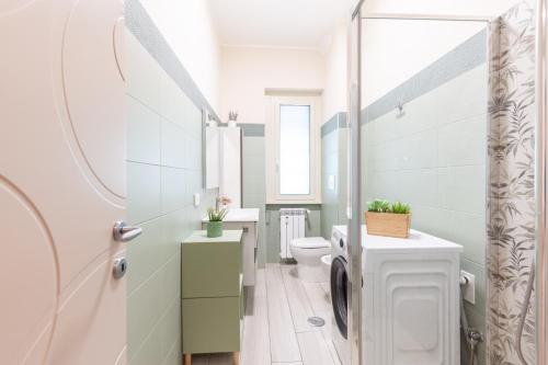 a bathroom with a toilet and a sink at Hostly- Don Bosco Light Lodge in Rome