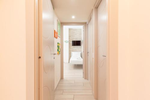 a corridor of a bathroom with a toilet in the background at Hostly- Don Bosco Light Lodge in Rome