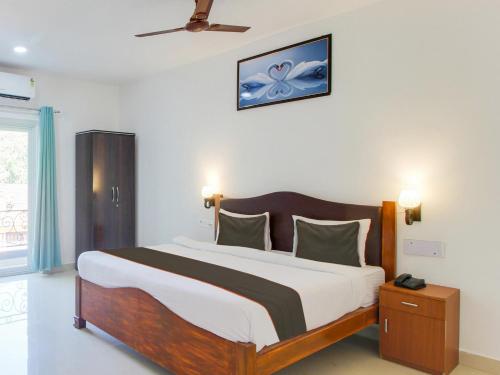 a bedroom with a large bed in a room at home and beyond by myroom in Goa