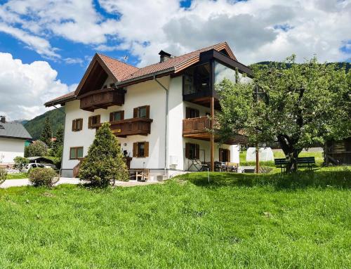 een groot gebouw met een boom ervoor bij Appartements Wiesenheim in Rasun di Sopra