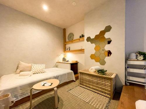 Many Thanks Resort Onomichi - Vacation STAY 15795 في أونوميتشي: غرفة نوم صغيرة مع سرير وطاولة